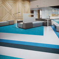 Modern interior with lounge seating, wood panel walls and blue and gray sculptured rubber tile flooring from the Burke ColorScape collection